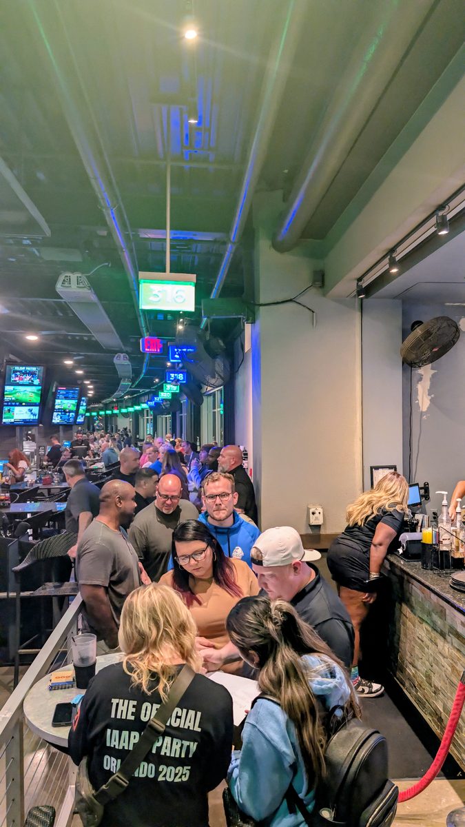 Guests arriving through the busy main floor at Topgolf